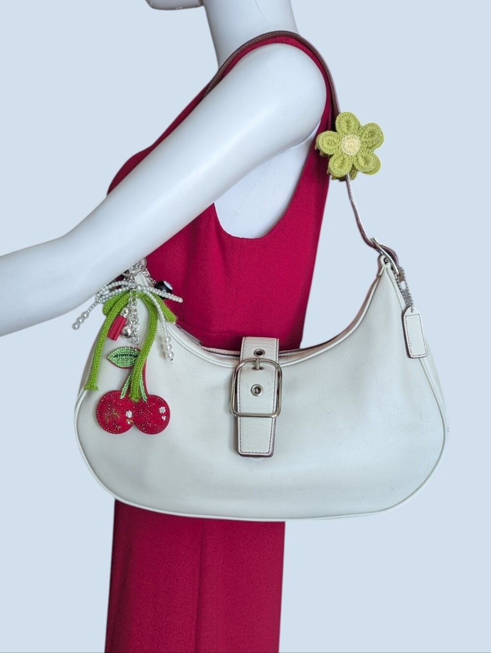 Coach Hamptons Hobo bagfeaturing a prominent buckle closure and custom charm